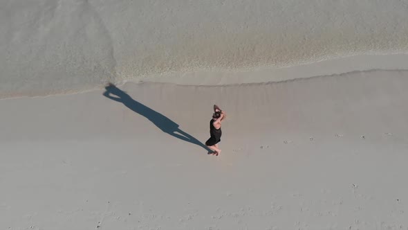 Girl Walking on the Beach  View From Above