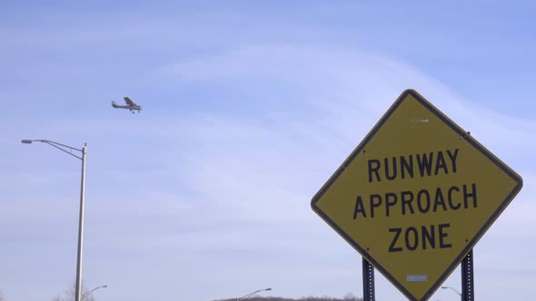 Plane Lands Near an Airport Approach Warning Sign alt