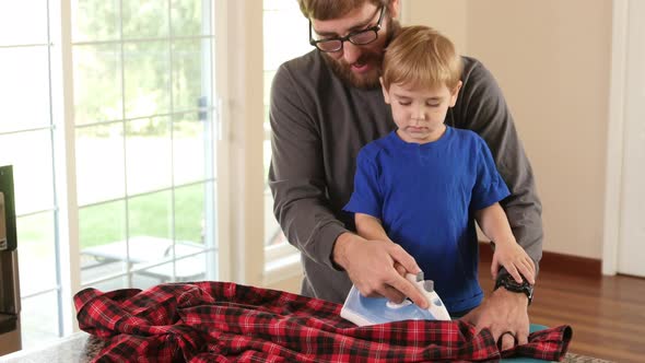 Father and Son ironing shirt together