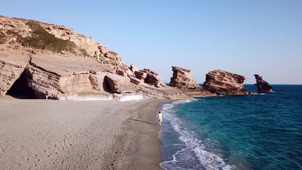 Aerial Drone Footage of a Girl Running Along a Lonely Beach