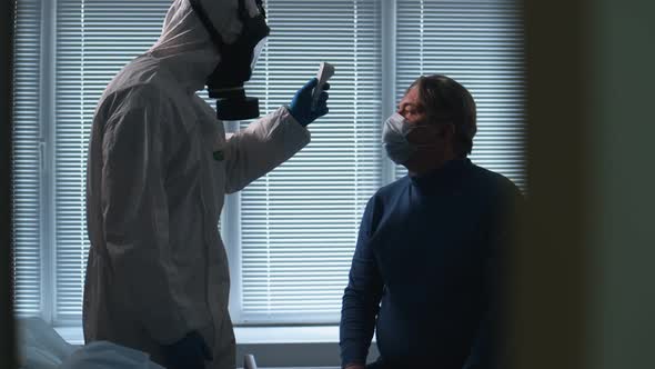 Coronavirus, Covid-19 Infected Patient During Test in Hospital. Man Gets His Temperature Tested for alt