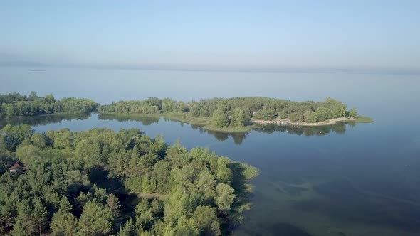 Calm Amazing Aerial Top View on Landscape with Wide River and Small Islands, Covered Forest