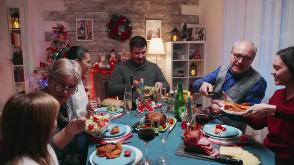 Big Family Celebrating Christmas with Delicious Food alt