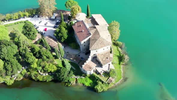 Aerial footage viewing a Castle at the lake with green water alt