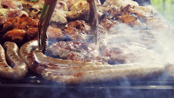 Grilled Sausage On The Flaming Grill. Bearbeque Outdoors with other meat on it, pork, chicken, mitit alt