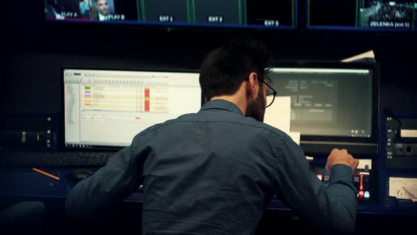 Operator On TV Channel Studio Room. Studio Director On Video Mixer Broadcast TV Station. Engineer TV alt