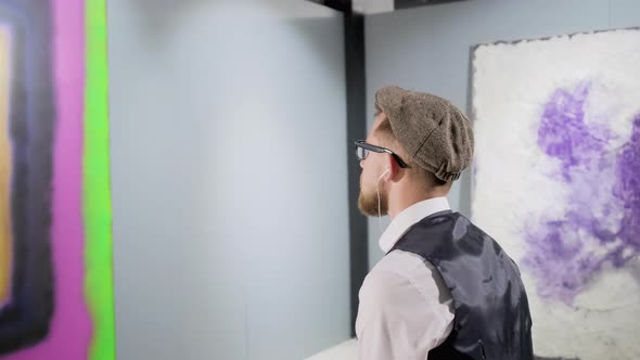 Art Lover Is Looking on Amazing Abstract Picture in Musuem Camera Moving Around alt