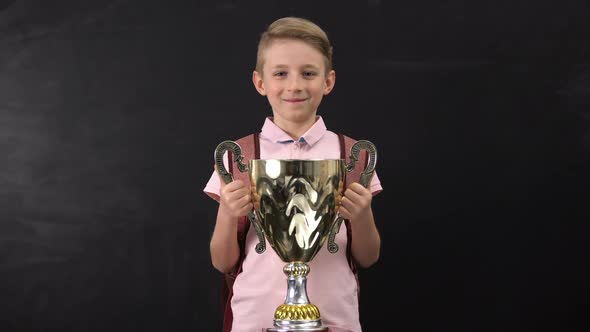 Happy Schoolboy Holding Bowl Award alt