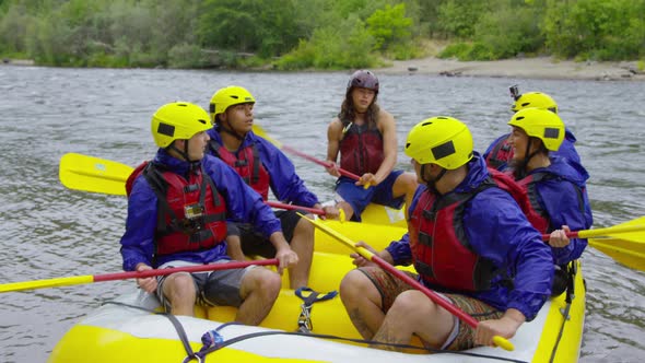 Group of people white water rafting celebrate