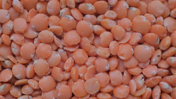 Heap of Red Lentils on Slow Rotating Surface  Macro Close Up Top View