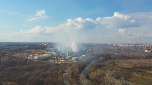 Aerial Shot of Industrial Plant Which Emitting Carbon Dioxide to Nature alt