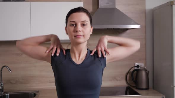 A Young Sweet Girl Doing Exercise at Home Standing in the Kitchen