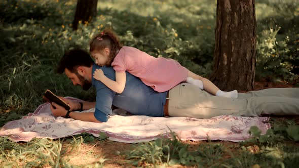 Little Kid With Father Reading Book. Daddy Reading Fairy Tale Story. Father Day. alt