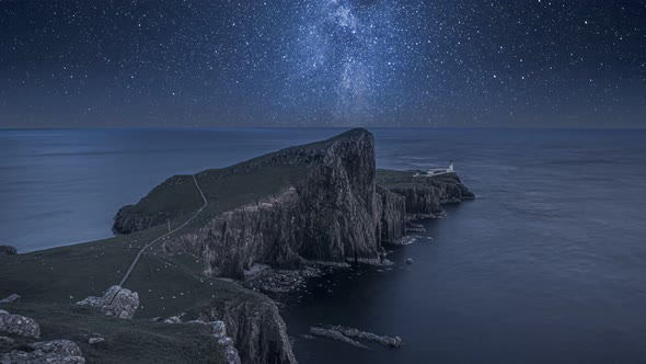 Milky way over the Neist point lighthouse at night, Scotland alt