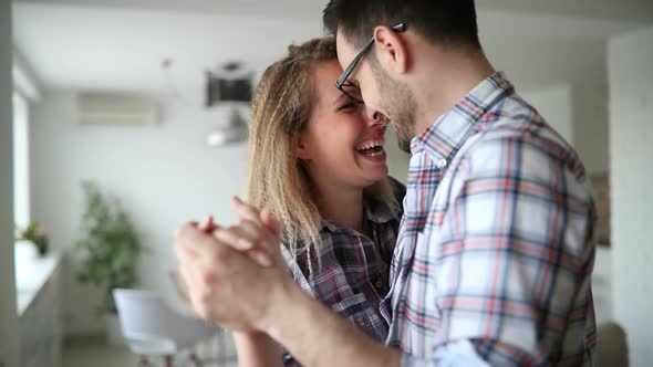 Woman Having Fun Dancing with Her Husband at Home Smiling