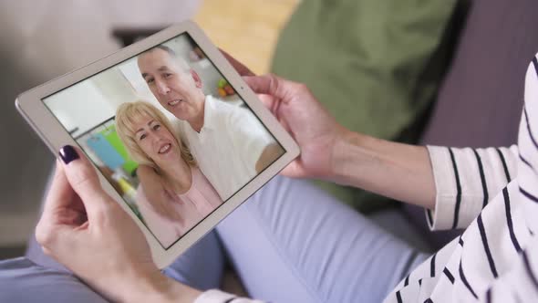 Closeup Shot: Girl Daughter Chatting with Parents Via Skype Video Call with Tablet alt