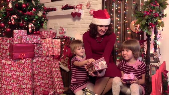 Christmas Kids, Happy Children Opening Gifts., Wooden Background alt