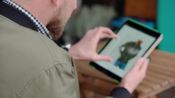 Man Is Shopping Online He Is Examining Catalog of Male Clothes in Site of Store alt