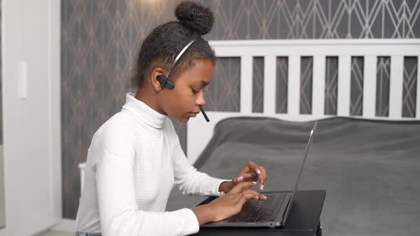 Homeschooling Online a African Teen Girl Uses a Laptop to Study on Selfisolation at Home Studying alt