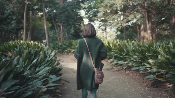 Young Girl Is Walking In The Garden