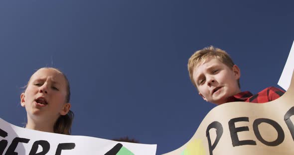 Group of kids with climate change signs in a protest alt