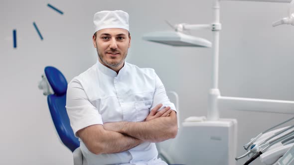Portrait of Smiling Dentist Doctor in Uniform Posing at Stomatology alt