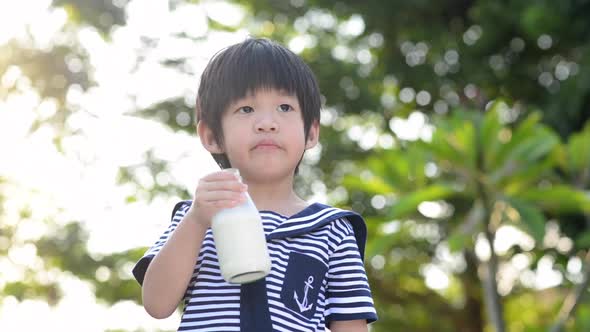 Asian Child Is Showing Dislike Drinking Milk Expression alt