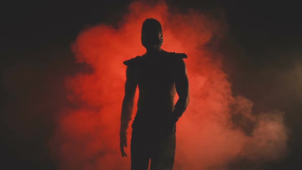 Silhouette of a Dancing Man in Mask
