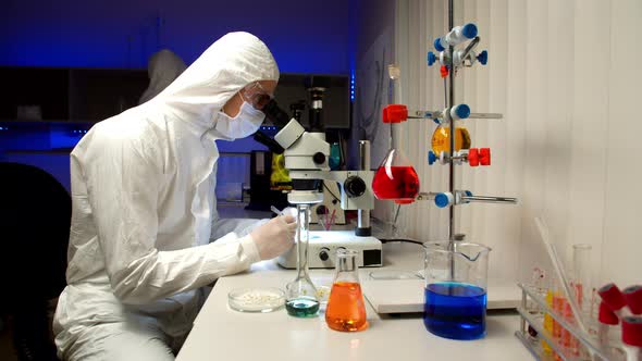 Scientist Examining Samples with Microscope