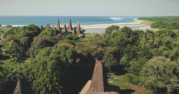 Aerial View of Unique Indonesia Houses Roofs at Ocean Bay Sand Coast Green Tropic Jungle Landscape alt