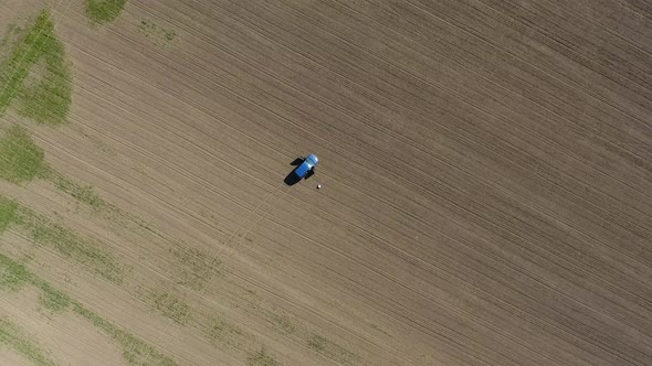A Vertical View From a Drone a Blue Car Stands in the Fields of Winter Wheat