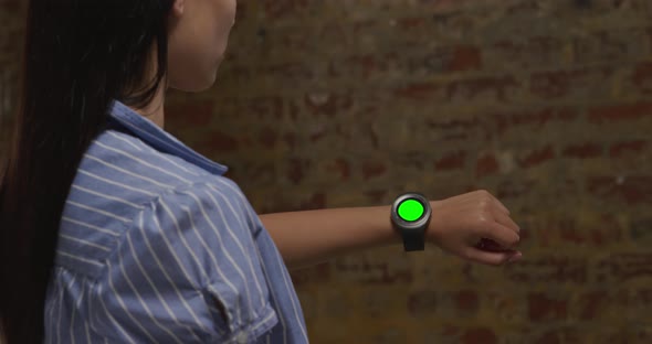 Woman checking smartwatch alt