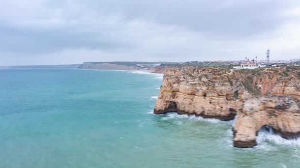 Aerial Drone Hyper Lapse Circling Around Beautiful Lagos Algarve Coastline with Waves Crashing alt