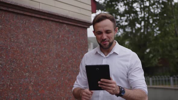Conversation of Young Man with Tablet on the Street alt