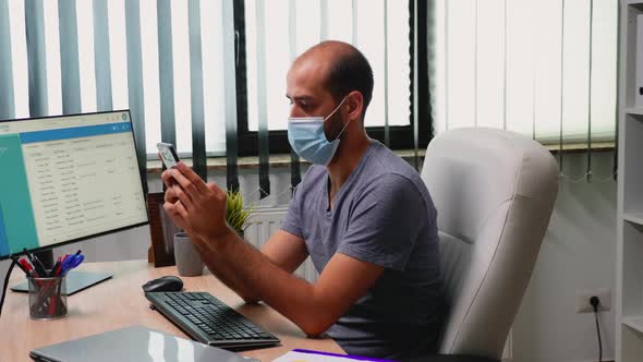 Typing on Phone Wearing Mask alt