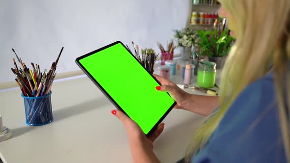 Blond White Woman Swipein the Tablet