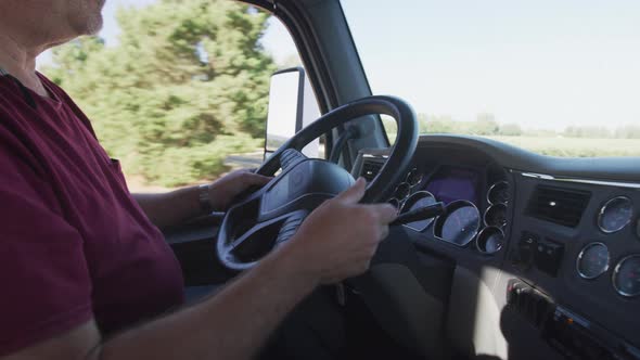 Interior shot of truck driver driving semi truck.  Fully released for commercial use.