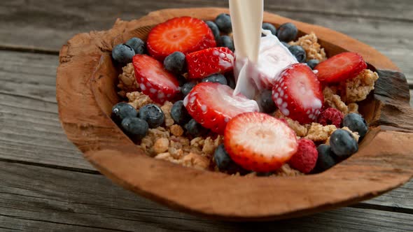 Pouring Milk on Cereals in Bowl in Super Slowmotion. alt