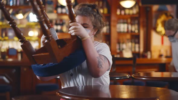 Waiters Wearing Protective Face Mask Cleaning Restaurant Before Opening alt