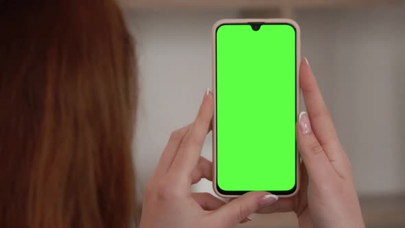 Handheld Camera: Point of View of woman Using Phone With Green Mock-up Screen Chroma Key Surfing Int alt