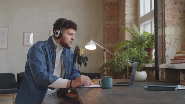 Man Hosting Podcast in Recording Studio alt