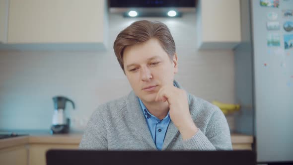 Man Thinking While Sitting at the Computer alt