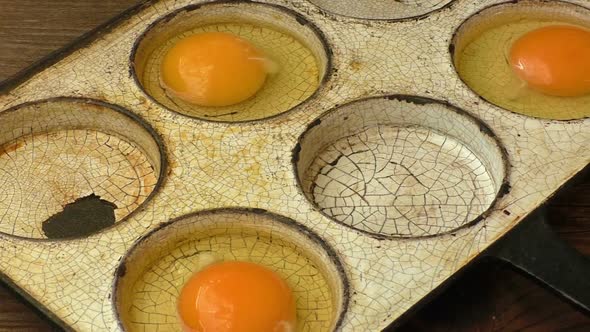 Chicken eggs in a frying pan. Rustic style.