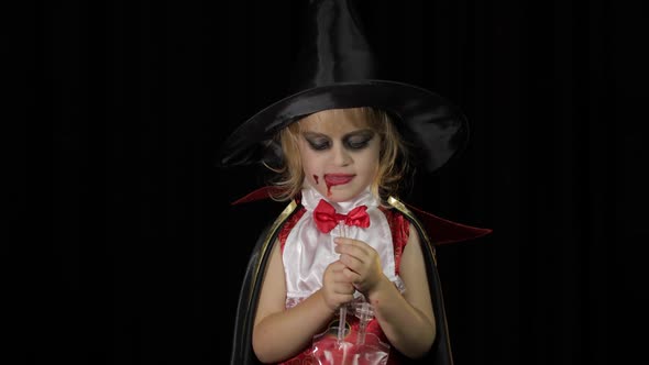 Dracula Child. Girl with Halloween Make-up. Vampire Kid with Blood on Her Face alt