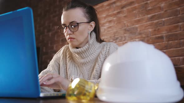 Female Engineer Working Intently at a Laptop