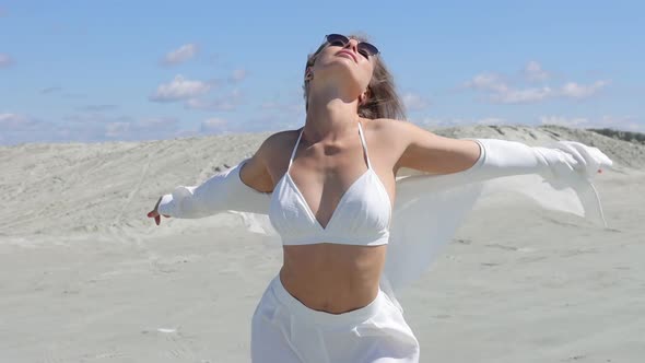 Charming Woman Standing on Beach on Windy Day