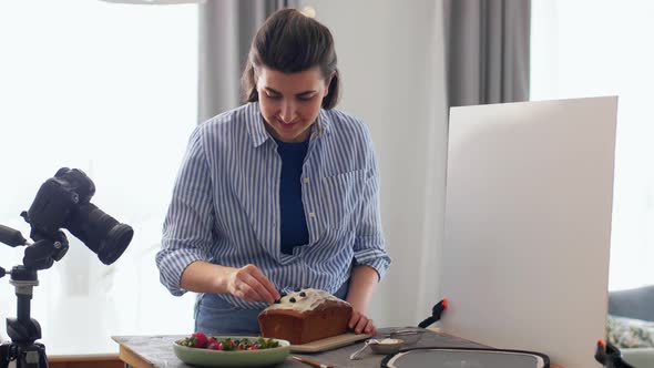 Food Blogger with Camera and Cake in Kitchen alt
