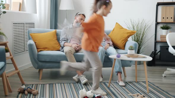 Tired Parents Mother and Father Sitting on Couch Looking Unhappy While Active Daughter Running, Stock Footage 