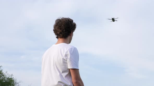 Young Man Doing Somersault Backward Flip Under Drone Flying Above, Slow Motion alt