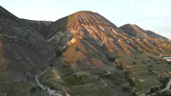 Mountain peaks in the rays of the setting sun, aerial view, drone video.